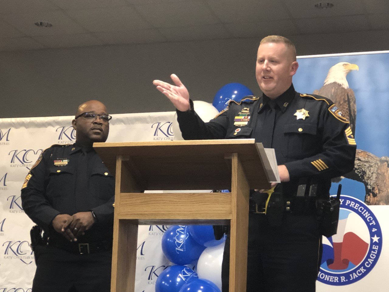 Harris County Sgt. Tommy Smith, left, listens as Sgt. John Klafka speaks at the dedication of a victim service and support center at Katy Christian Ministries.